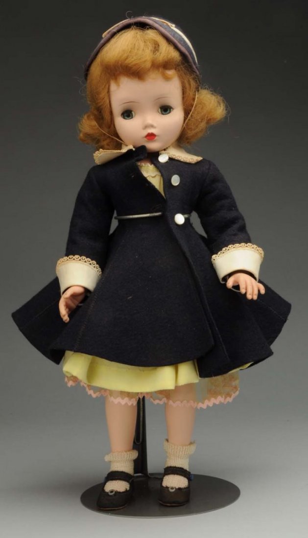 Madame Alexander “Binnie Walker.”: All hard plastic doll, blonde hair, lashed sleeping eyes, original tagged taffeta dress (tiny hole in front) and felt coat with matching hat, undies, shoes and socks, wrist tag also. Stringing a littl