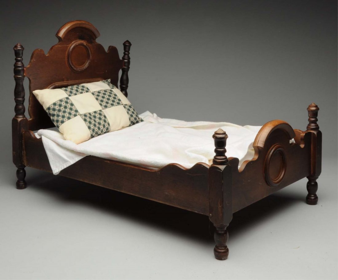 Wooden Doll Bed.: Very nice Victorian piece with well designed head and foot boards with carved decoration and turned spindles (wear on one finial, general overall light wear and side slats need to be glued in tightly)