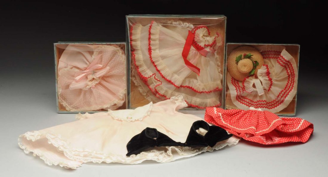 Box Lot of Madame Alexander Clothing.: Black vest for “Brigitta;” red cotton dress for “Cissette;” pink baby dress and slip with Alexander tag; boxed set of dress, slip, panties and hat No. 0447 with Alexander-kins tag; boxed pink 