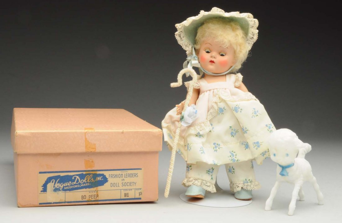 Vogue Hard Plastic “Ginny” Doll.: “Bo-Peep” Strung, painted-lash doll with sleeping eyes and original poodle caracul wig; all original crisp clothing with wrist tag, staff and white plastic lamb in original labeled box. Just a won