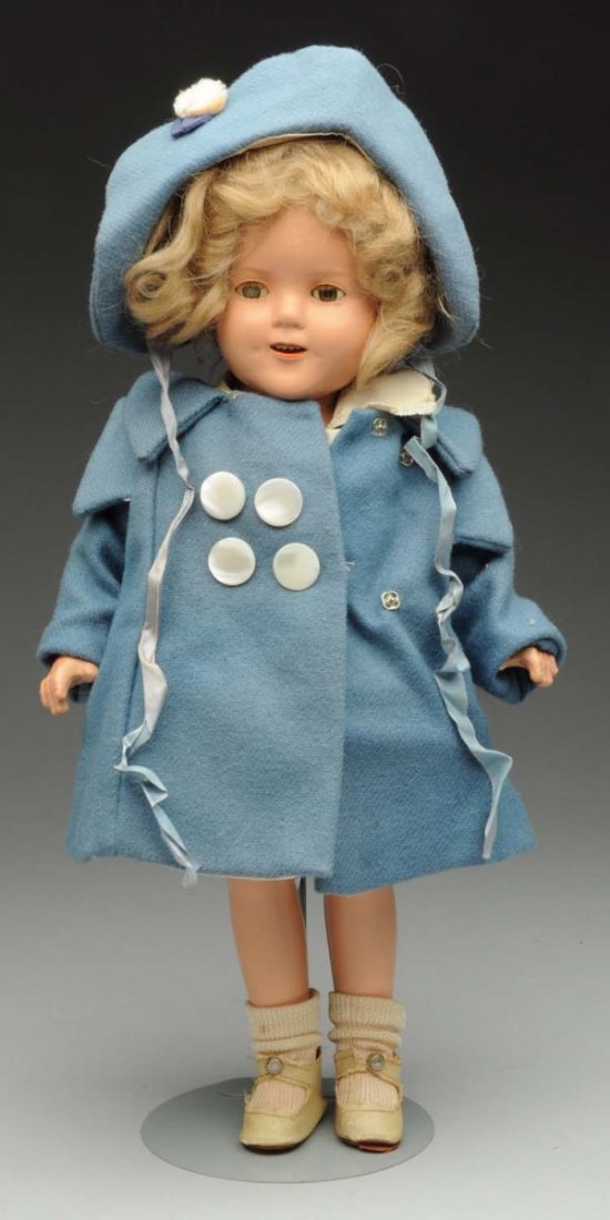 Ideal “Shirley Temple” Doll.: All composition marked head and body with good color (light crazing, needs restringing), lashed sleeping eyes (one cloudy), original mohair wig (needs setting), dimples; crisp factory dress looks orig