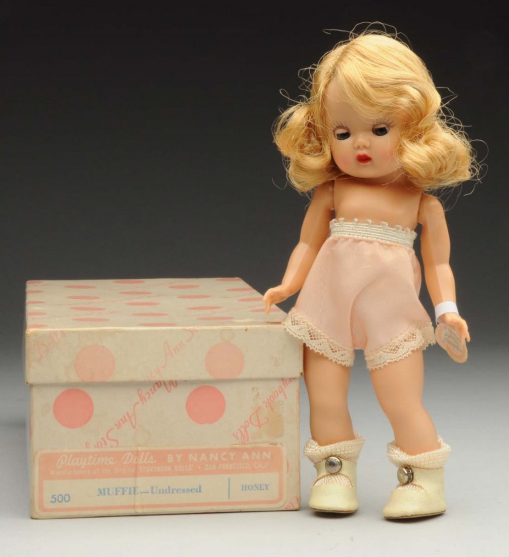 Nancy Ann Hard Plastic “Muffie” Doll.: 1953, strung basic Muffie with original mohair wig, booklet and repaired wrist tag, original labeled box. Condition (Excellent). Size 8".
