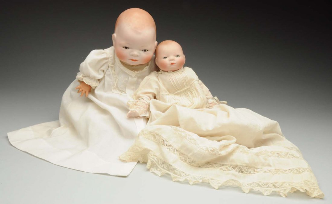 Lot of 2: “Bye-Lo Baby” Dolls.: Both with signed bisque heads and sleeping eyes; larger with original signed cloth body and celluloid hands (one finger glued) with vintage undies and new dress; smaller with new body and antique clot