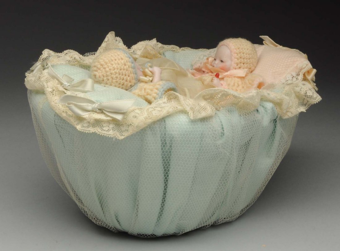 Darling Set of Twin Babies in Basket.: Pink bisque German babies with painted features, open mouths, jointed shoulders and hips, molded bottles in left hand; beautifully dressed with diapers, booties, slips, dresses, hats and sweaters in a