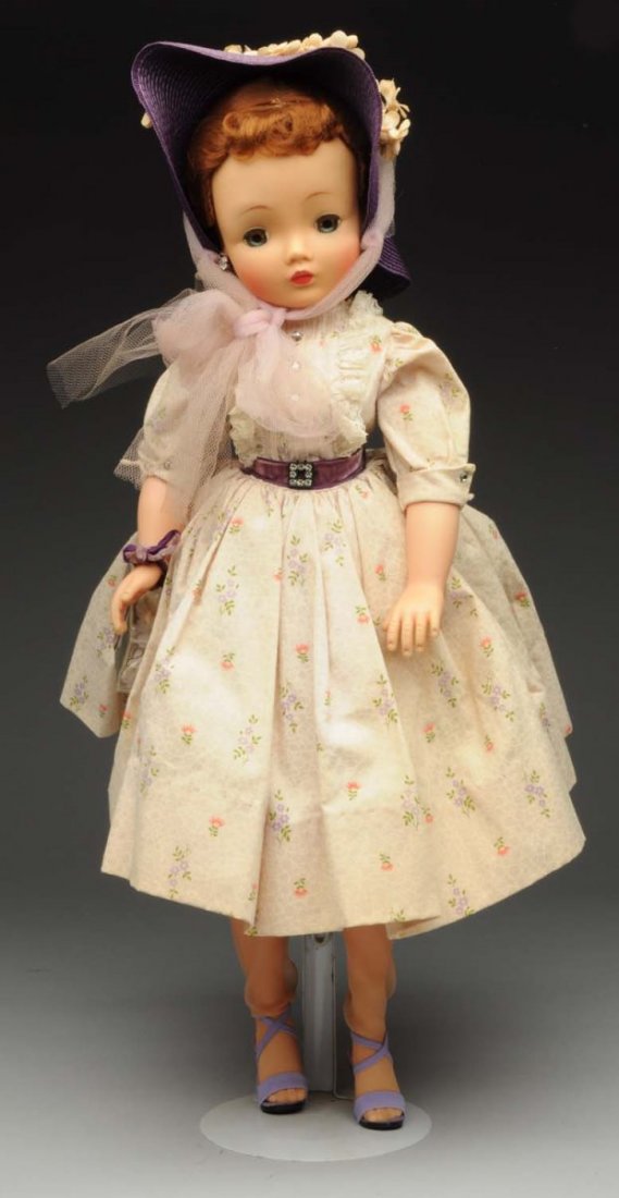 Alexander Hard Plastic “Cissy” Doll.: Original wig, lashed sleeping eyes, tagged cotton shirtwaist dress with purple straw hat carrying her corsage box. Lovely face! Condition (Excellent). Size 20".