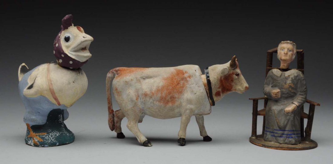 Lot of 3: Candy Containers.: This lot includes a chicken with light overall wear, a cow with light wear, and a woman on a chair with a rocking head. Moderate wear to the woman. Condition (Very Good - Very Good Plus). Size Largest