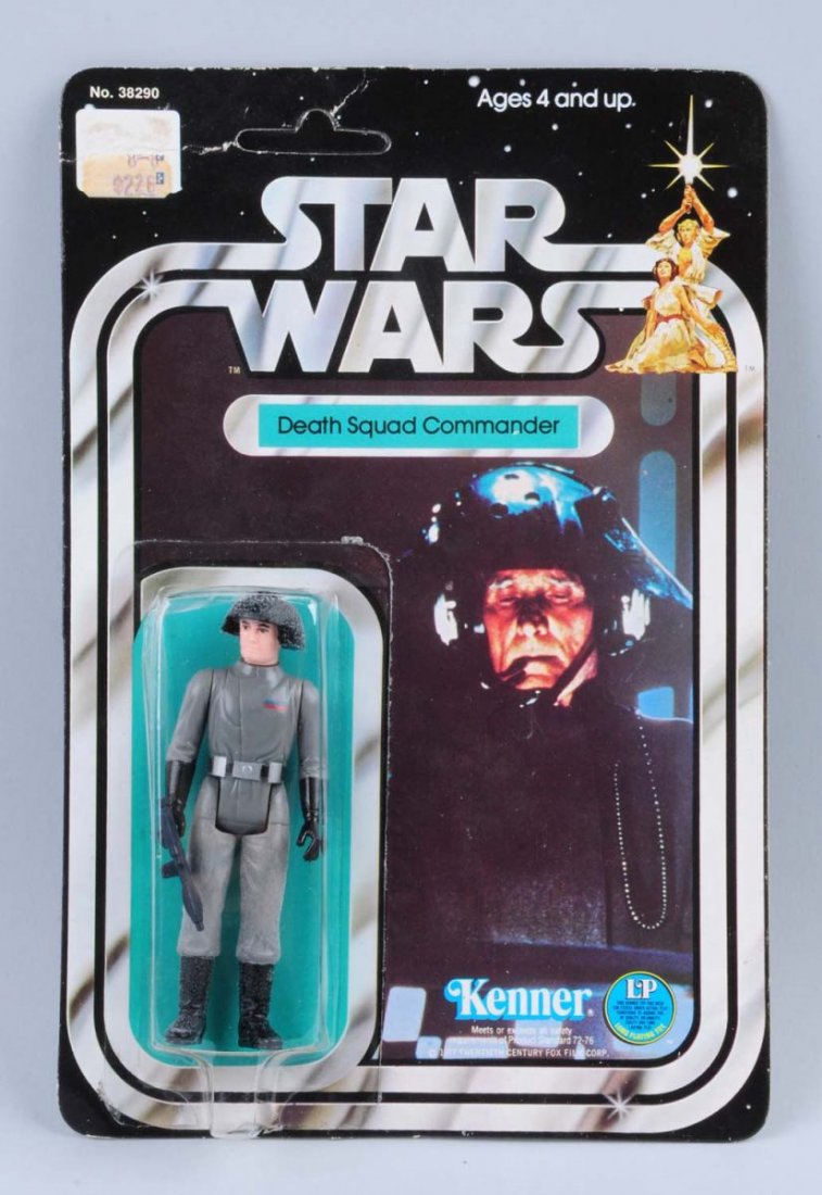 Star Wars Death Squad Commander Carded Figure.: Circa 1977. Kenner, Hong Kong. Unpunched. Original price tag is on the upper left hand corner. There is a creasing on a section of 2” on the upper left hand corner of the card. There is a 2” inden