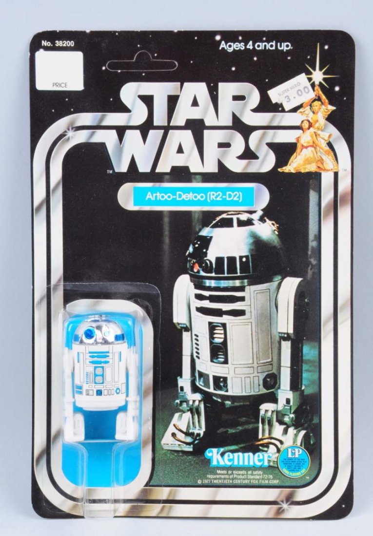 Star Wars Artoo-Detoo (R2-D2) Carded Figure: Circa 1977, Kenner, Hong Kong. Unpunched. The original price tag is attached on the upper right hand corner of the card. One of the corners of the price tag is paper pulled. The figure and bubble are 