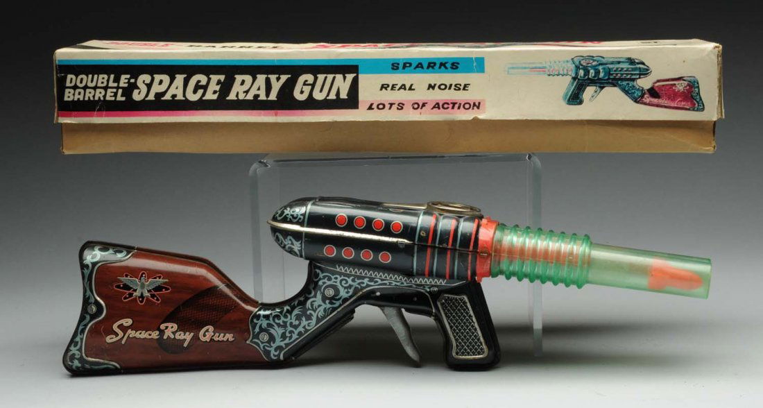 Japanese Tin Litho Space Ray Gun.: Friction - powered. Gun has significant scratching throughout. As well as several spots of oxidation, otherwise colors are beautiful. includes two plastic missiles; one of the front section is detache