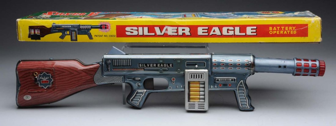 Japanese Tin Silver Eagle Space Gun.: Battery - operated. Tin section of the gun has slight scratching throughout as well as some slight oxidation. Comes with original box; has some creasing and slight paper tears. Condition (Very Good -
