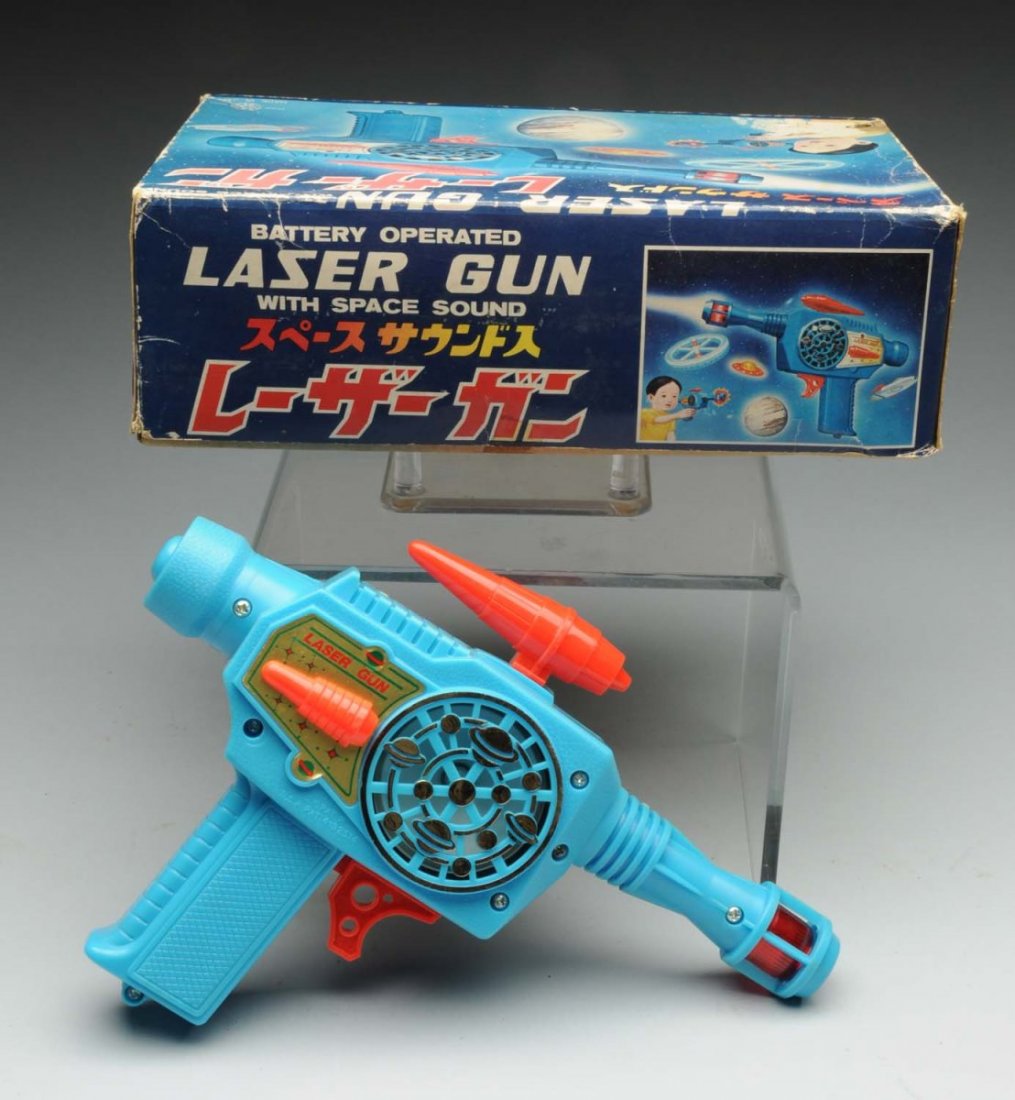 Japanese Battery - Operated Plastic Laser Gun.: Gun appears to be in unused and unplayed condition. Side of gun has a sticker that says "Laser Gun" on both sides. Also comes with original box; includes original insert. Box has some slight creasing