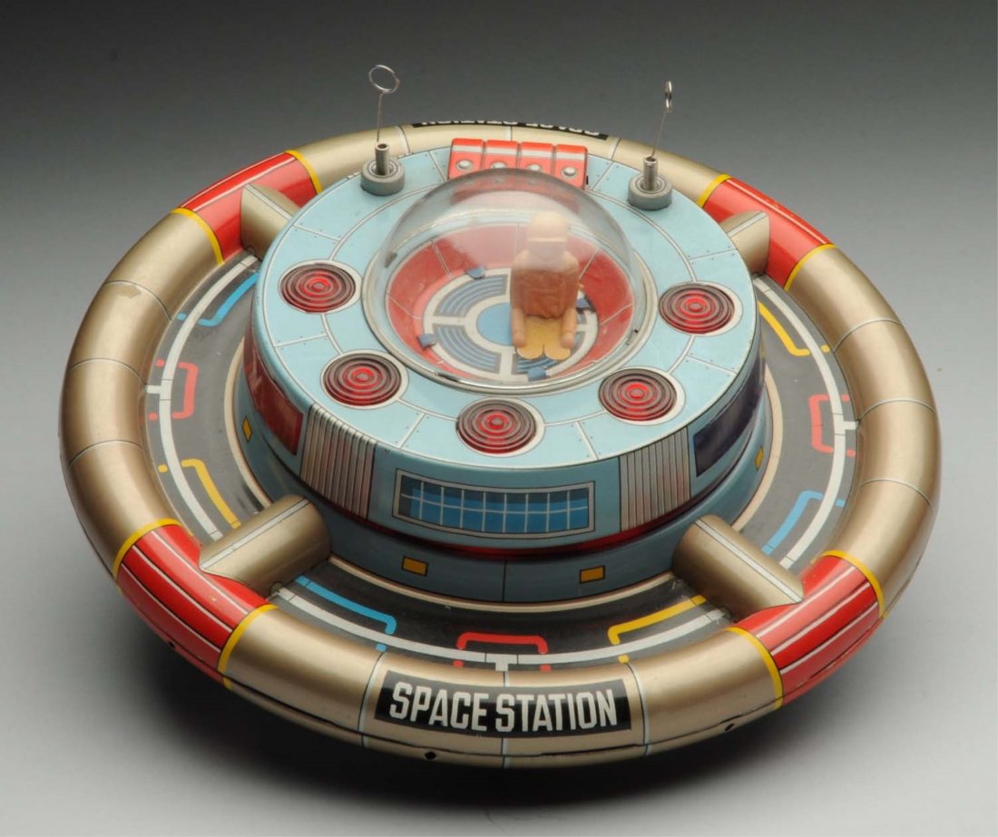 Japanese Tin Litho Battery-Operated Space Station: Includes original antenna. Plastic dome has no cracking. Marked "Space Station" on the front. Nice action toy. Could be cleaned to a better grade. Condition (Very Good). Size 8" L.