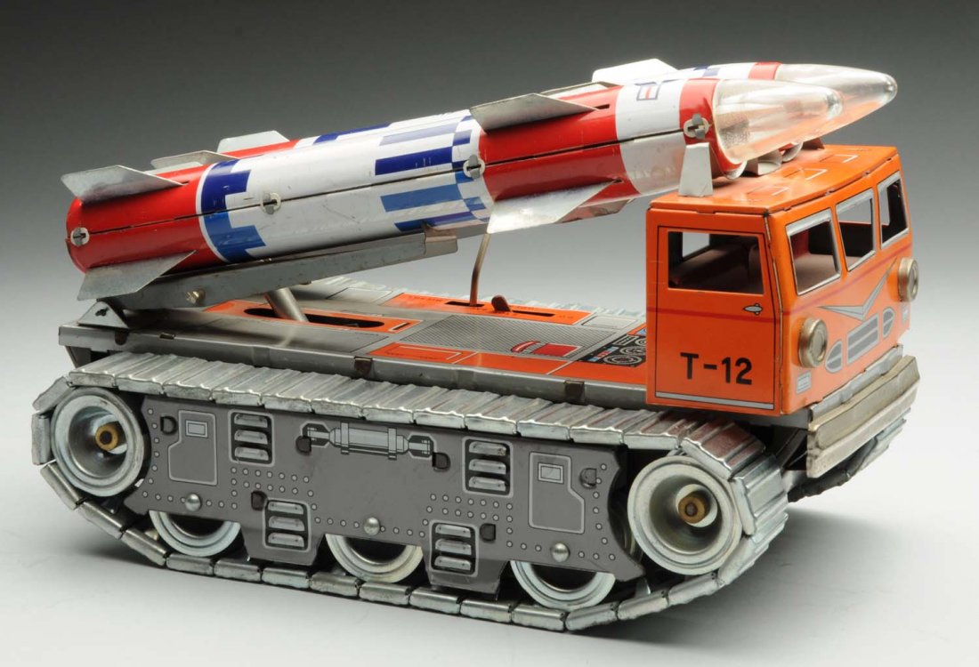 Japanese Battery Operated Rocket Transporter.: Vehicle hauling two Titan missiles. Marked "U.S.A.F." Includes original metal treads. Tough piece to find with missiles. Some scratching and wear. Condition (Very Good). Size 10" L.