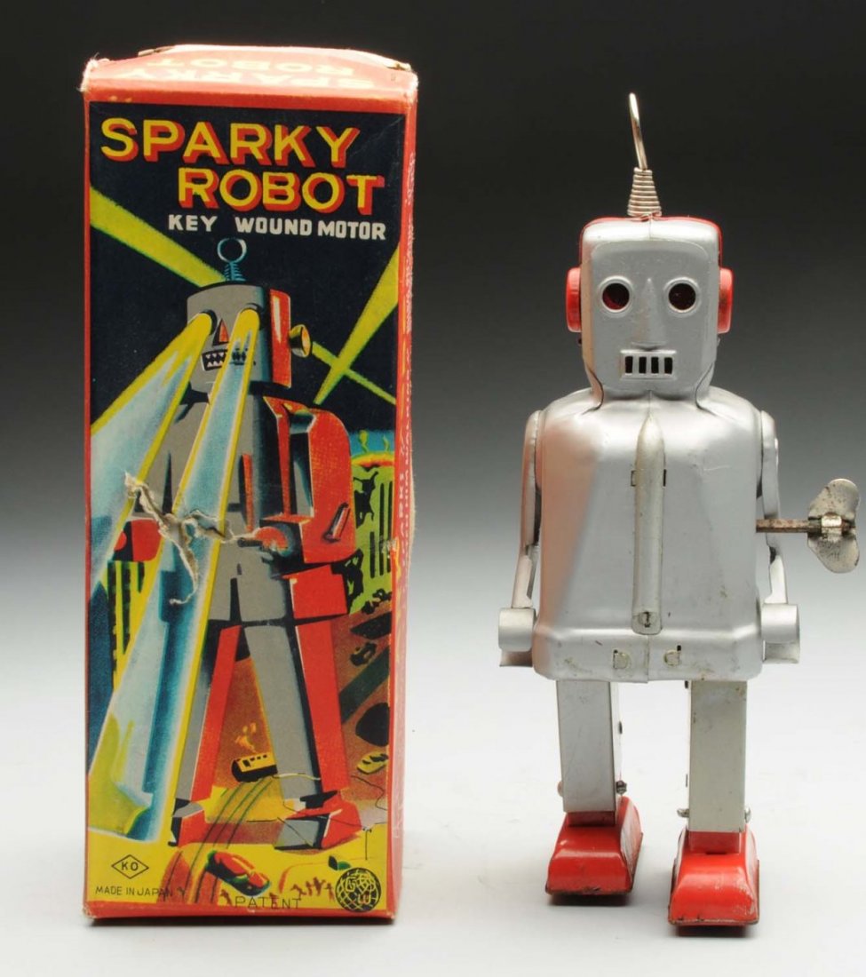 Japanese Tin Litho Wind-Up Sparky Ronot.: Includes colorful original box, which has some staining on the bottom. Designed by George Wagner. Condition (Very good - Excellent). Size 8" T.