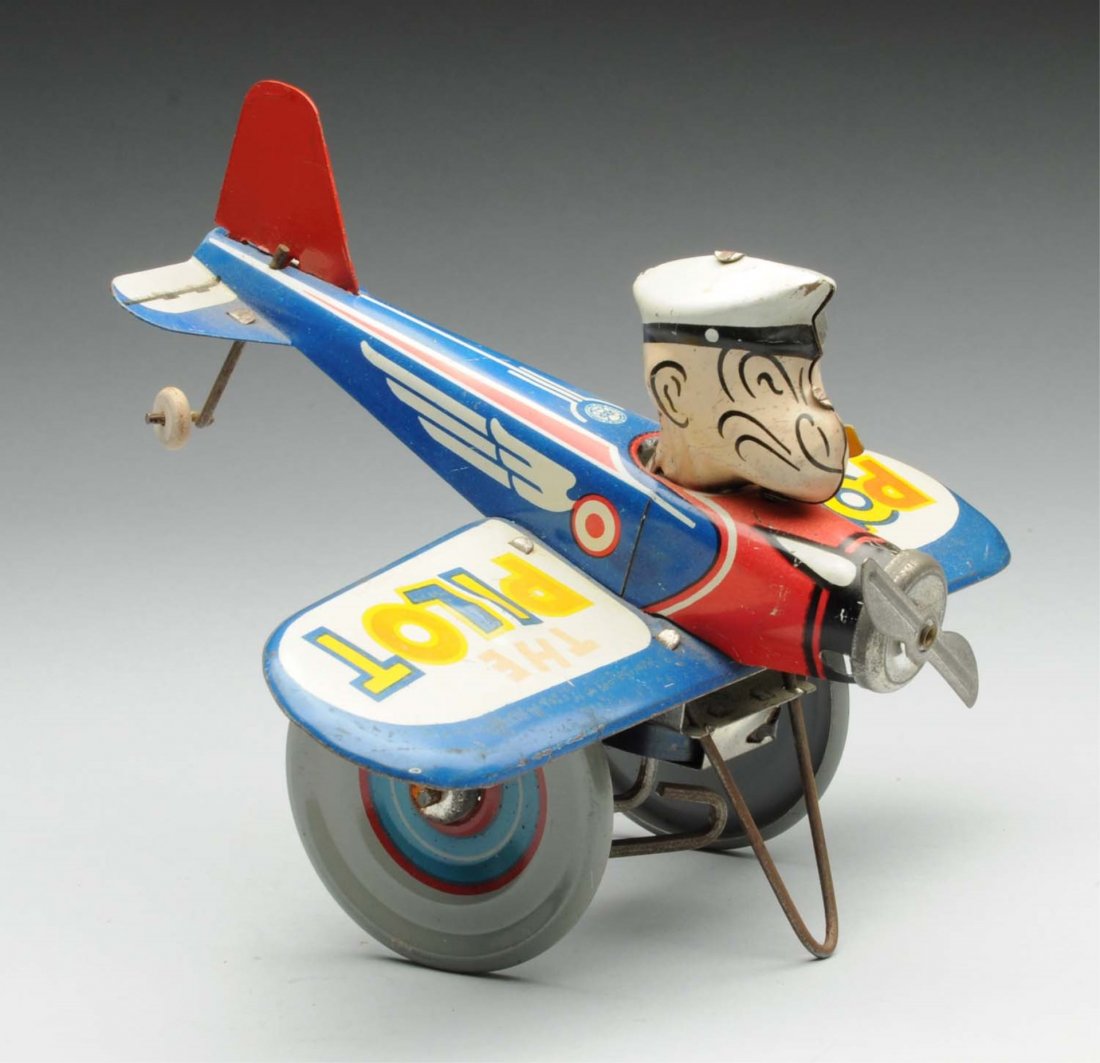 Marx Tin Litho Wind-Up Popeye the Pilot Toy.: 1940s version. Original front propeller and pipe, but possible replacement tail fin. Some slight fading, scratching, and wear. Marked "King Features Syndicate" on wing. Condition (Very Good). Size 7" 