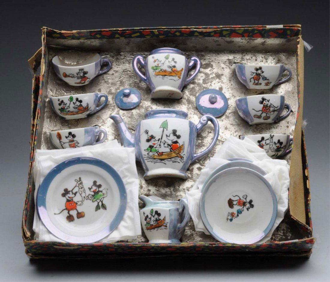 Walt Disney Mickey & Minnie Mouse Tea Set.: Japanese. 22 piece set marked "Made in Japan". Includes teapot, creamer, sugar with two lids, six cups, and 11 plates. One plate is cracked,and teapot has slight line cracking and is missing the lid.