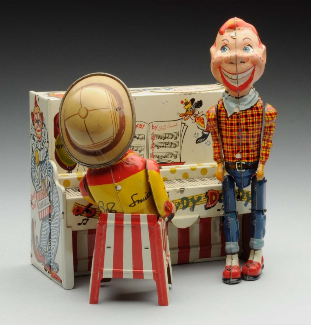 Unique Art Tin Litho Howdy Doody Band Toy.: Depicts Howdy Doody dancing and Bob Smith playing the piano. Includes partial original box, which is in pieces and needs to be put back together. Toy itself has some scratching to Howdy's nose and che