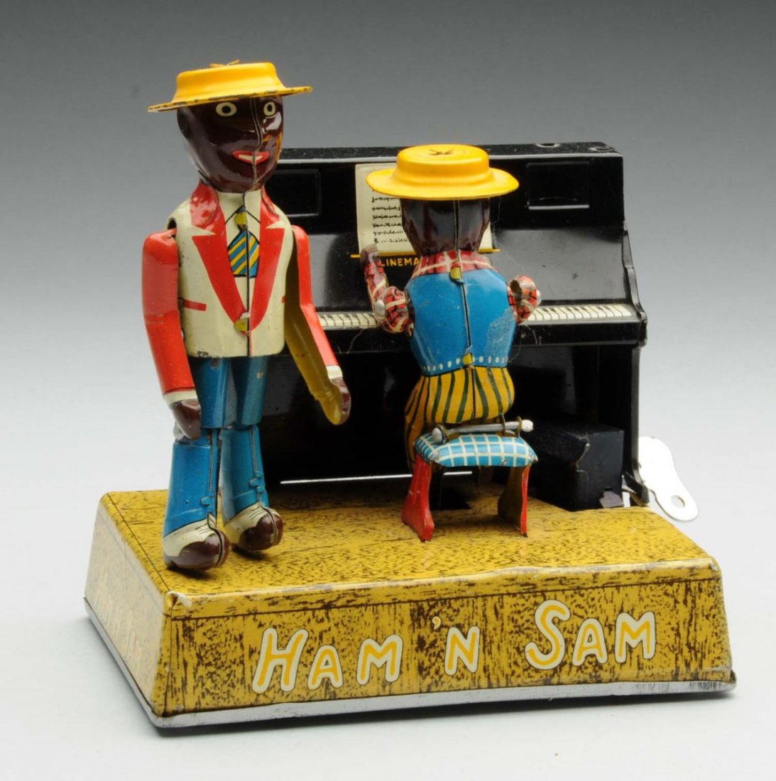 Scarce Linemar Tin Litho Ham & Sam Band Toy.: Small variation of the original toy. Original hats and arms. Marked "Ham & Sam" on base. Some minor scratching and wear around the piano and the hat brims. Condition (Very Good - Excellent). Size 5" L