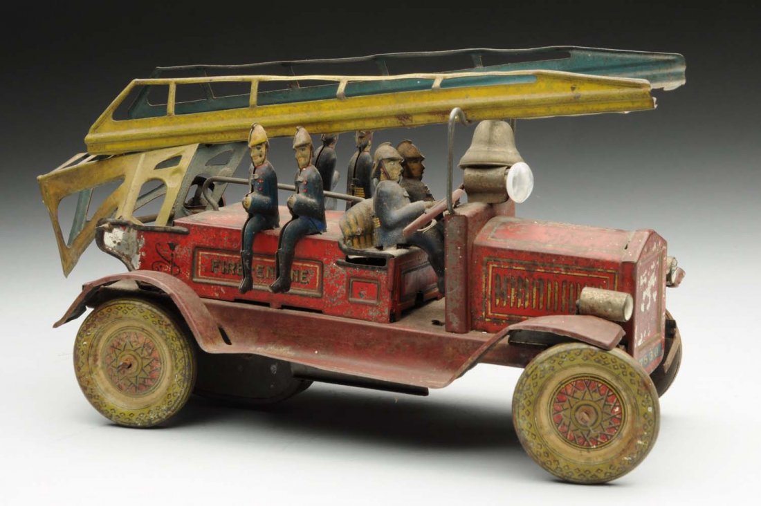 Japanese Tin Litho Pre-War Fire Ladder Truck.: Made by T.N. Japan. Truck has original ladders, six firemen, and original headlights that are missing bulbs. It is marked "Fire Engine" on both sides. There are some spots of litho loss and it has oxi