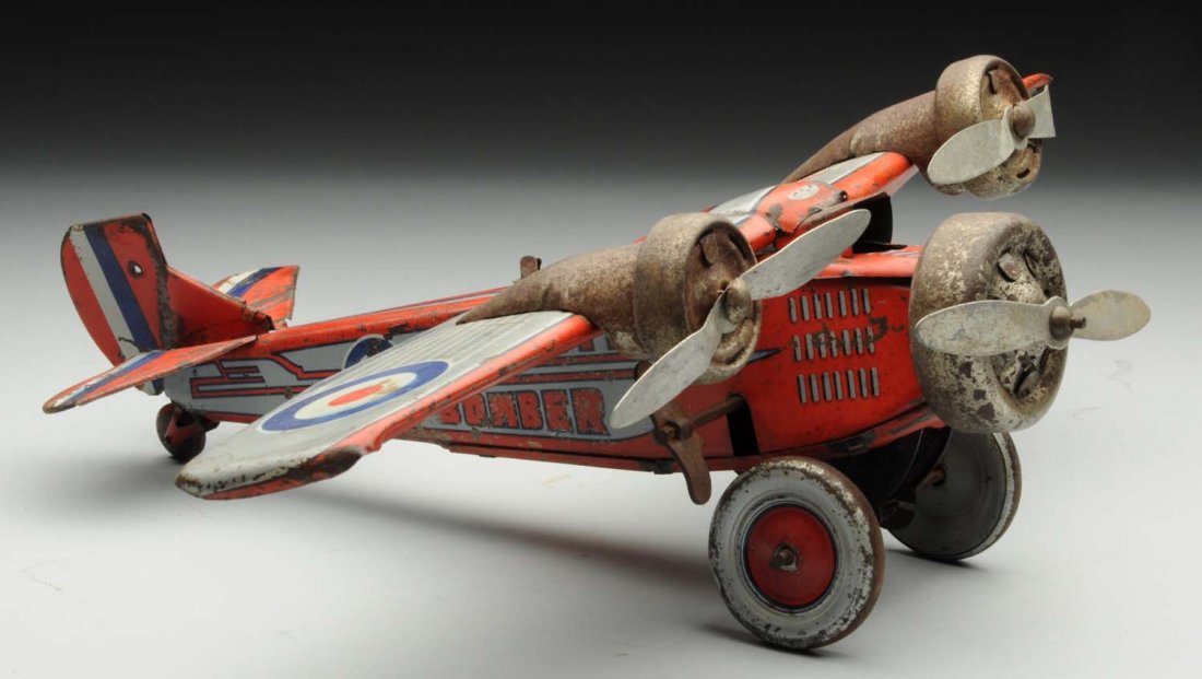 Japanese Tin Litho Wind-Up Pre-War Airplane Toy.: Lithographed "Martin Bomber" on wing. Plane has its original propellers. There is some bending to wings and tail fins. Marked "Made in Japan" on top wing. There has been some repainting to the lithogr