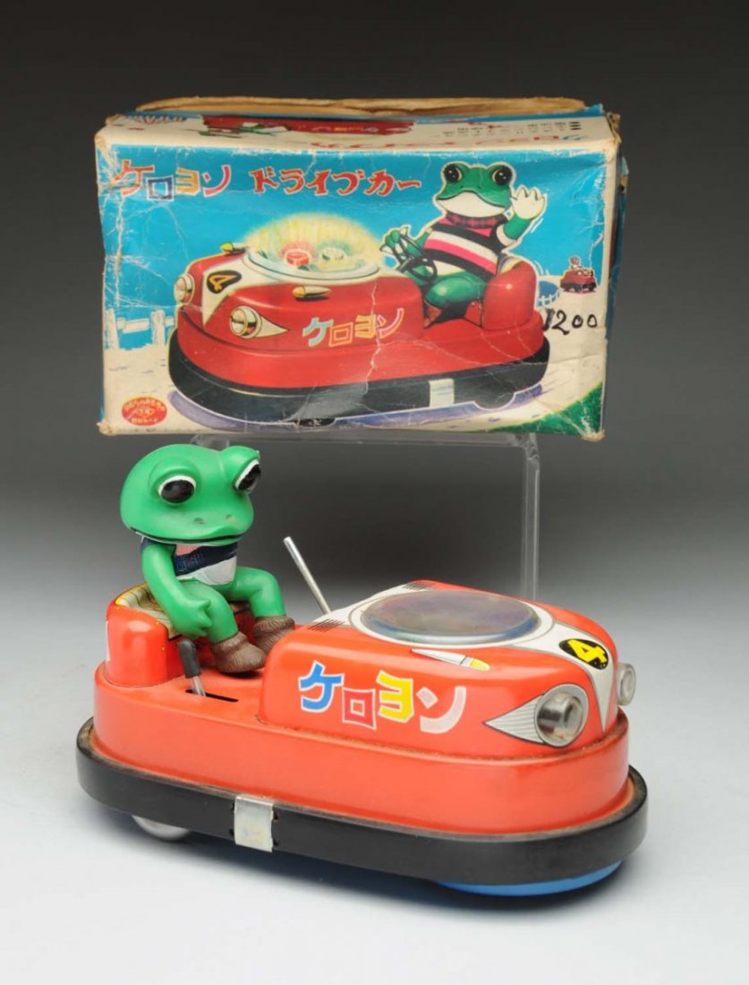 Scarce Japanese Battery-Operated Keryon Scooter.: Comes with original box made by TN. Box has some creasing and wear throughout. Toy itself is all tin, the frog figure is vinyl. Missing steering wheel, otherwise complete. Condition (Very Good). Size 