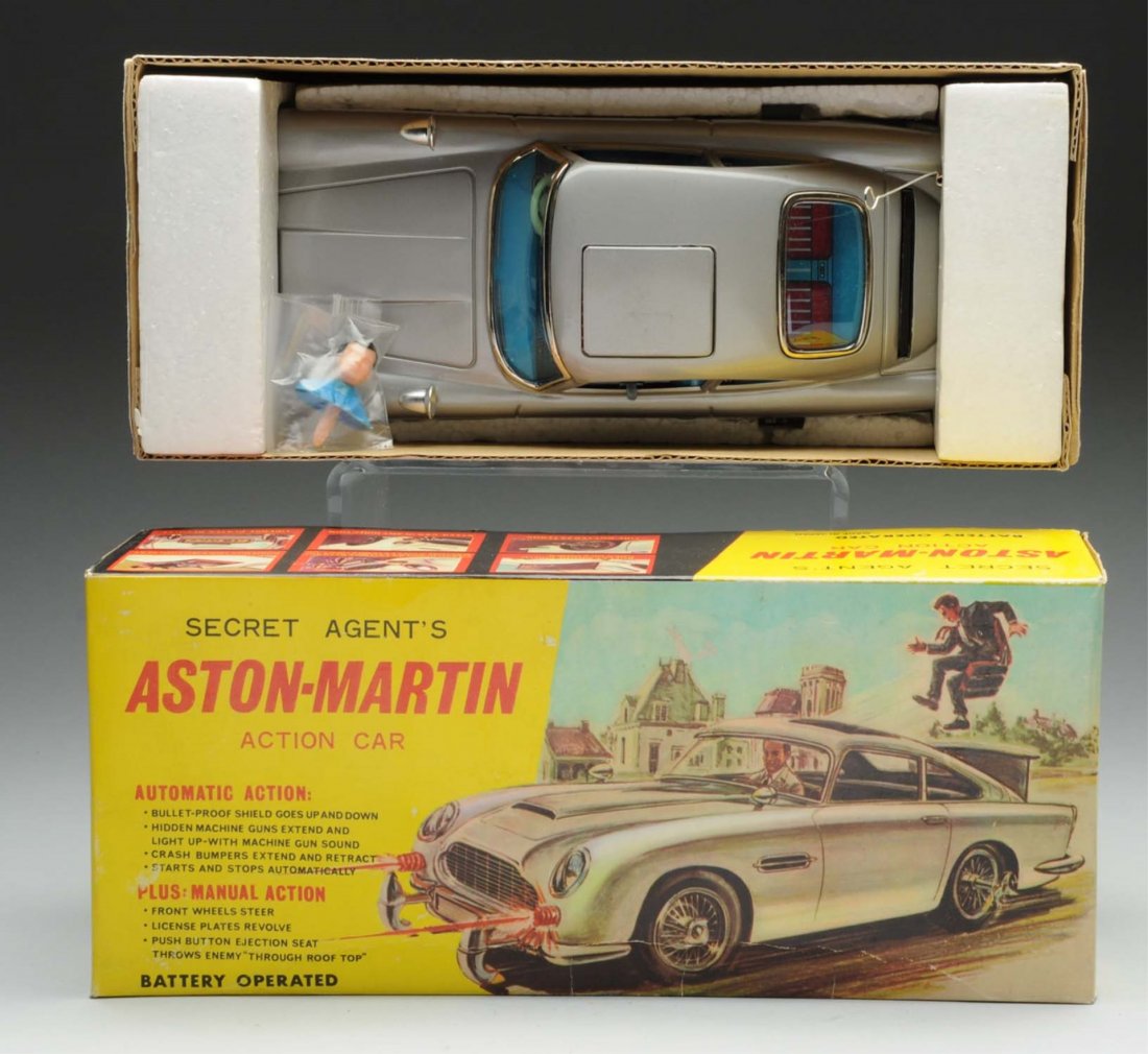 Japanese Aston-Martin Secret Agent Car.: This battery-operated car includes original box. All inserts complete. Shows Sean Connery in drivers seat on box. Car has a sticker on the bottom over the "James Bond" sticker after they lost the lice