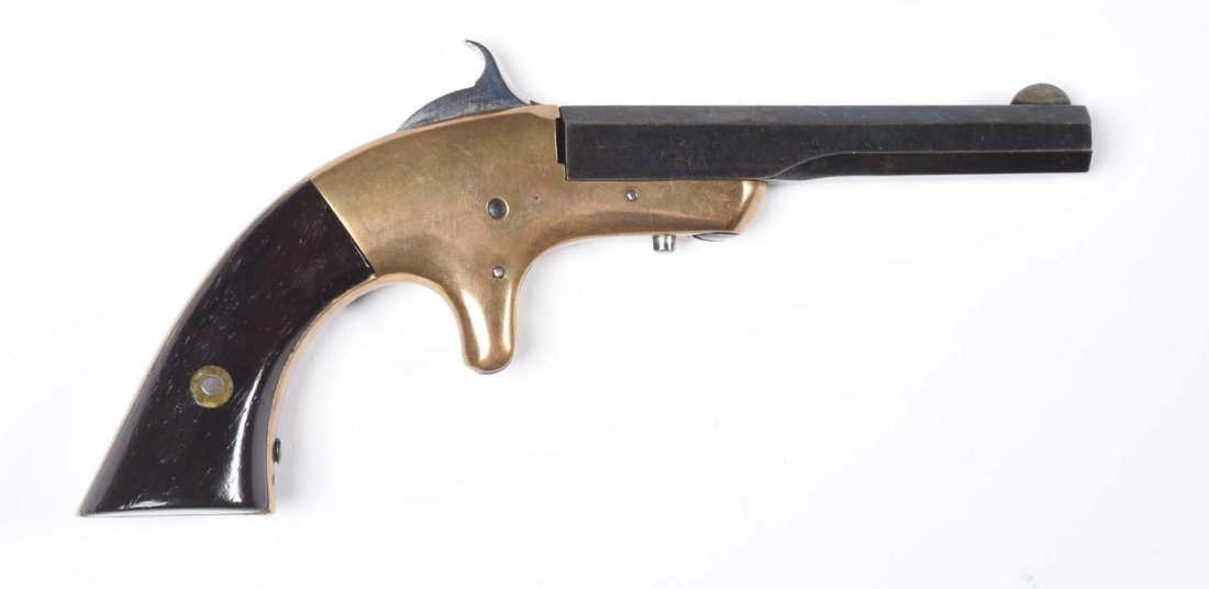 H.C. Lombard & Co. Single Shot Pistol.: Manufactured in the 1860s, under 1,000 made. Standard features include 3-1/2" octagon barrel, pivots to right for loading, single shot, spur trigger, varnished walnut grips, and brass frame. Entire gu