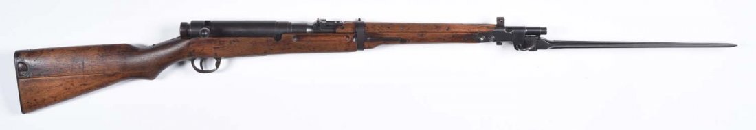 Japanese Type 44 Carbine.**: Caliber 6.5mm. Barrel is 19". Rear sight to 2000 meters, folding bayonet, two-piece buttstock. Partial mum. Has original dust cover. All metal is a brown patina with freckling. Several stock repairs. 