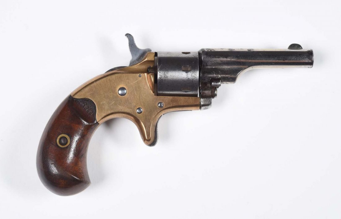 Colt Open Top Pocket Model Revolver.: Serial No. 24969. Manufactured 1874. Seven shot, .22 rimfire, 2-3/8" round barrel, Birds Head walnut grips, spur trigger, single action. Barrel retain 80% original nickel Cylinder is now in the white.