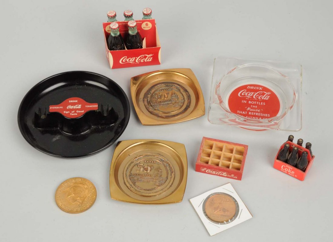 Lot of: Small Coca - Cola Items.: This lot includes several ashtrays, metal coasters, mini bottles and other items. Condition (Very Good - Excellent). Size Largest : 5" L.