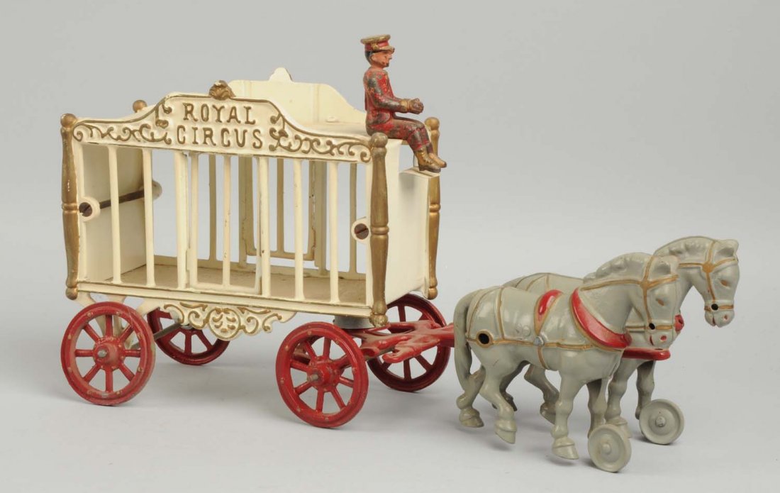 Cast Iron Large Hubley Royal Circus Wagon.: Missing animal, back axle broken. Has driver that might not be original to this toy. Two horses in front. Driver is original. The toy has been completely repainted. Condition (Repainted). Size 16" L.
