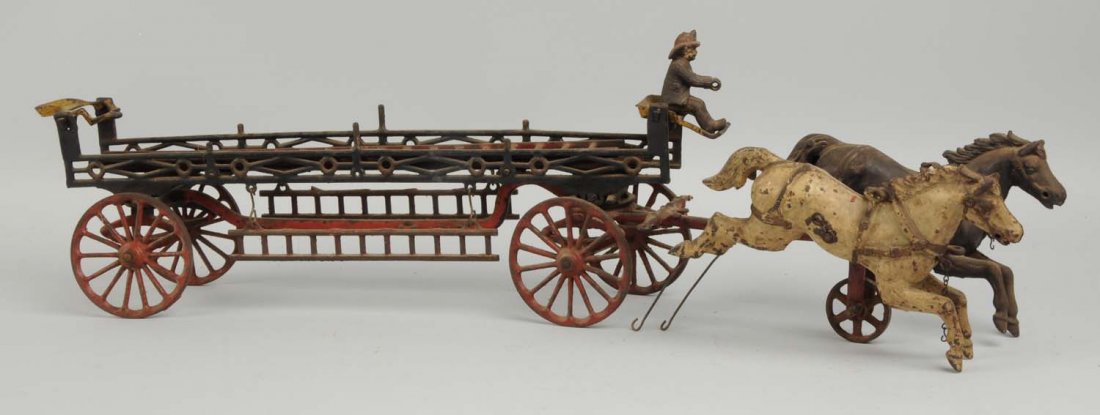 Cast Iron Horse Drawn Fire Ladder Wagon.: American made. Two horses in the front, missing chains. Does have original fireman driver. Includes two ladders, two large ones and two small ones. Missing rear driver. Some paint loss. Condition (Ver