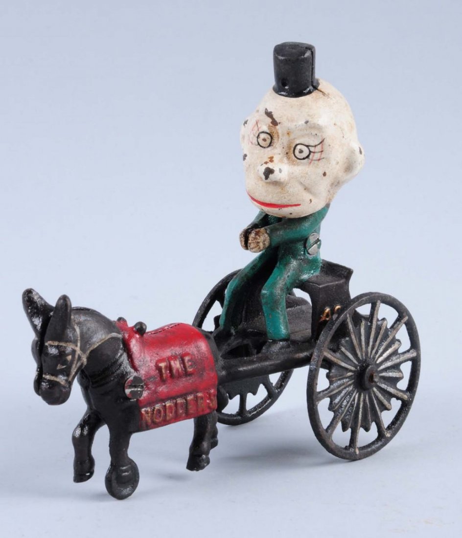 Contemporary Cast Iron Happy Hooligan: Embossed the Nodders on the donkey. Condition (Very Good). Size 6" L.