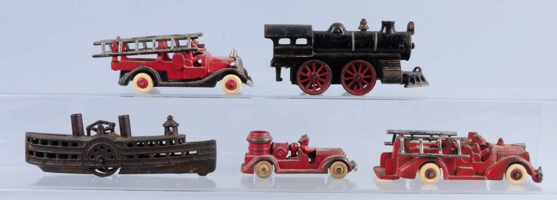 Lot of 5: Misc. Cast Iron Toy & Trains.: This lot includes: one cast iron train floor engine, a paddle wheel cast iron boat bank, and three Hubley fire and ladder trucks. Various conditions. Condition (Very Good). Size Largest : 8" L.