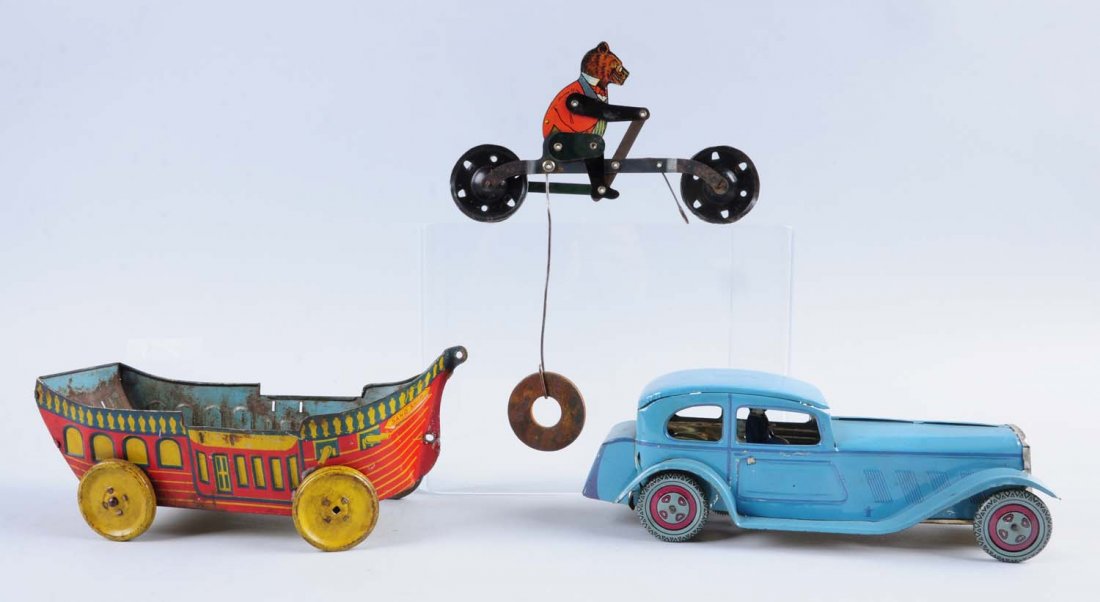 Lot of 3 Tin Toys.: Lot includes: a tin wind - up car made in England, a J. Chein & Co. tin sand ship with tin wheels, and a tin bear riding a bicycle but is missing a lot of parts. All toys have tin litho scratches and
