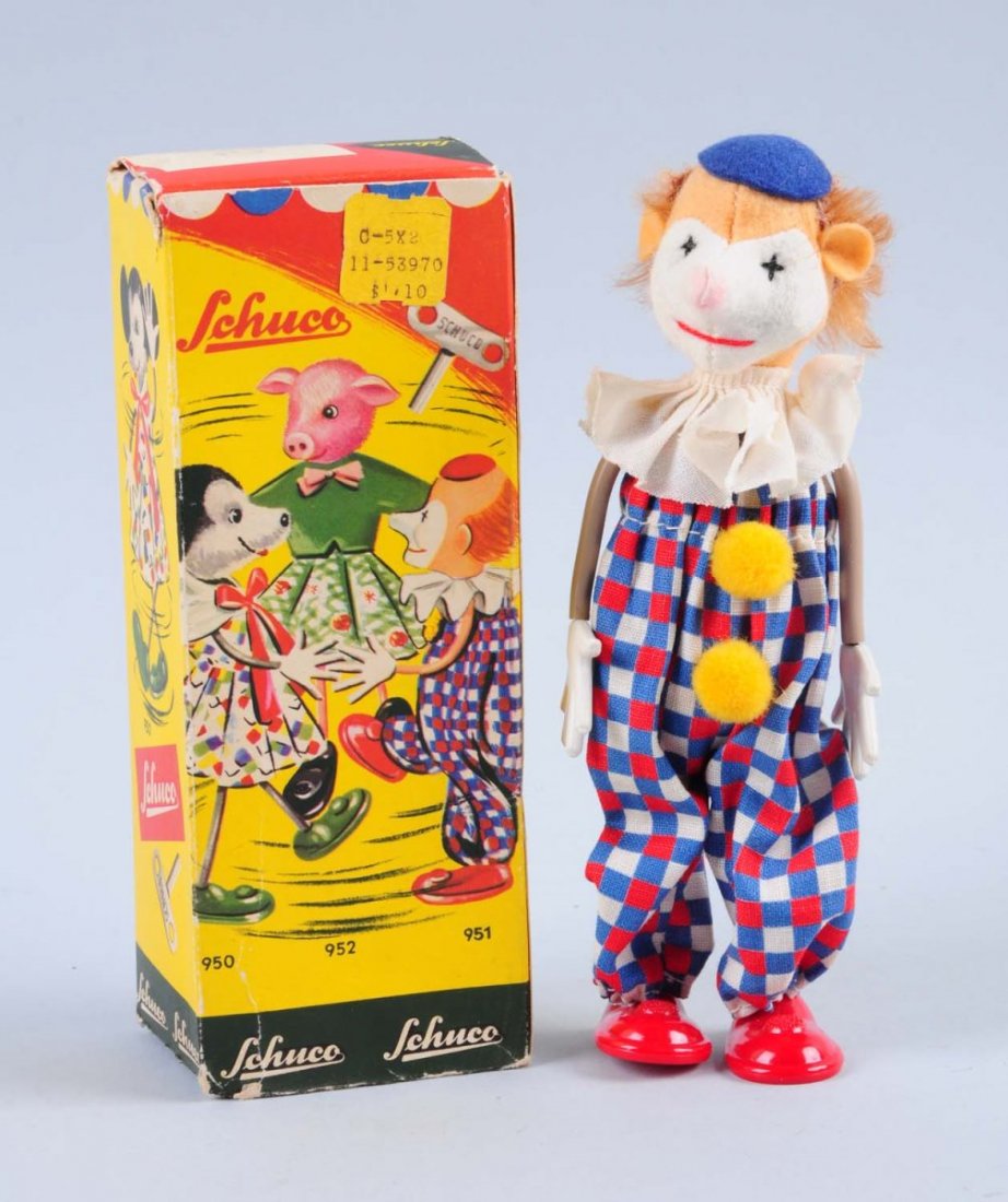 Schuco Wind - Up Clown.: Includes original box, missing one flap but is present. Slight creasing, paper pull and loss. The clown is in great shape, although has some slight stain marks on his white collar. Looks unplayed cond