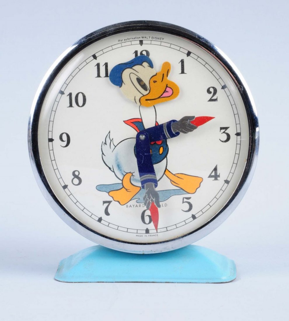 Disney Donal Duck Alarm Clock.: Made in France. Donald is on the face of the clock. The hands of the clock are Donalds hands and arms. Has a couple scratches. Wind - up keys are included. Condition (Very Good - Excellent). Size 5"