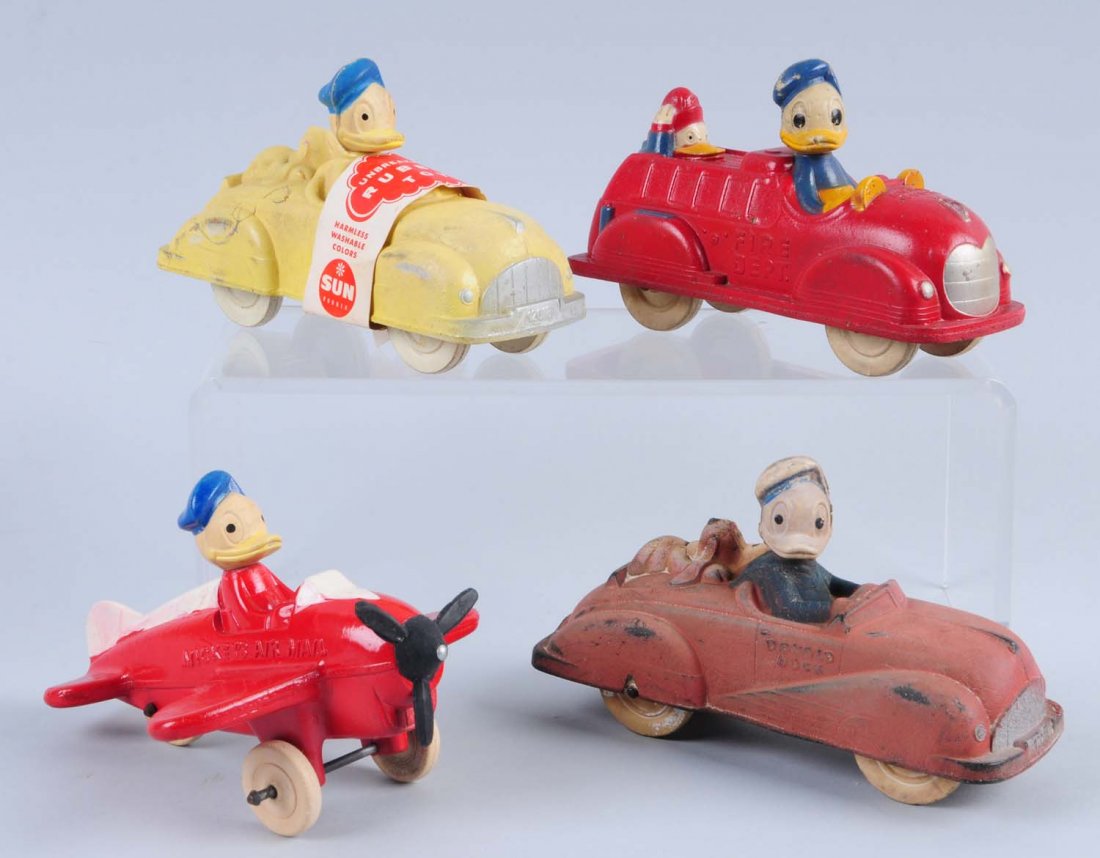 Lot of 4: Donald Duck Items.: Includes: one Donald Duck on a fire truck, two Donald Duck in regular cars and one Donald Duck pilot in Mickey Airmail. Colors are faded on one car. The plane appears to be repainted not professionall