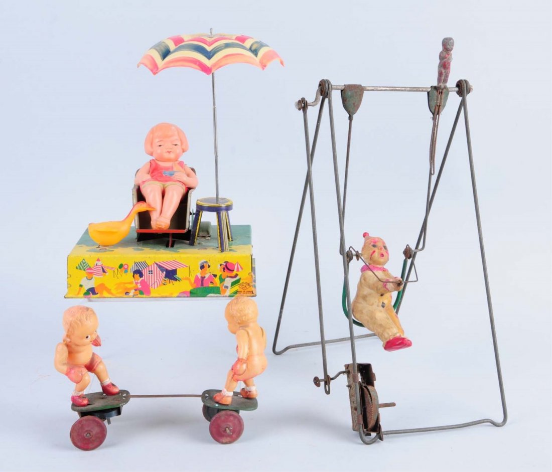 Lot of 3: Wind - Up Toys.: Made in Japan. Includes: a woman sitting on a beach with an umbrella, a gymnast clown, and two kids boxing. All the figures are made of celluloid. The tin and metal parts on all of the toys have some 