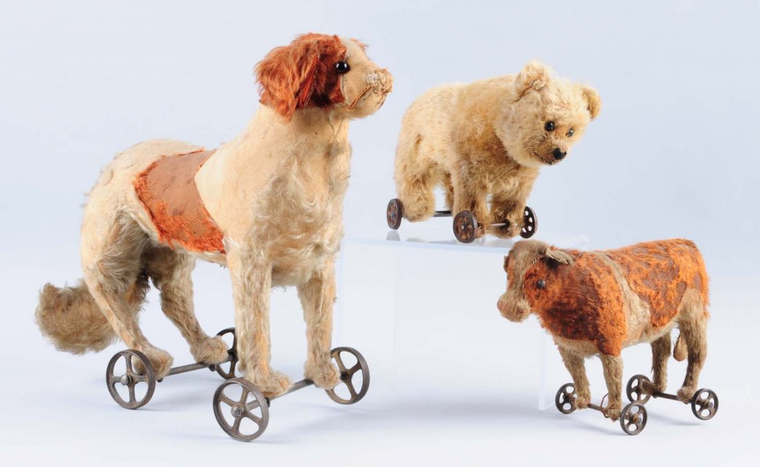 Lot of 3: Animals on Wheeled Bases.: This lot includes a dog with very heavy wear, a cow with heavy wear and a polar bear with minor wear. Condition (Poor - Very Good). Size Largest : 14" L.
