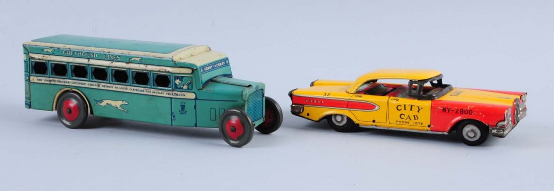 Lot of 2: Tin Litho Toys.: One is a city cab taxi, and the second one is a Greyhound bus. Both toys have some tin litho scratches and slight oxidation. Condition (Good - Very Good). Size 9"