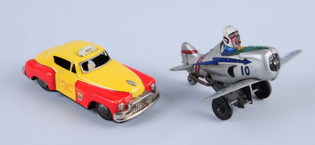 Lot of 2: Two Tin Toys.: The first one is a friction powered taxi and the second is a tin wind - up airplane. Both toys have slight scratches to the tin litho, the taxi has more scratches toward the bottom of the toy and some