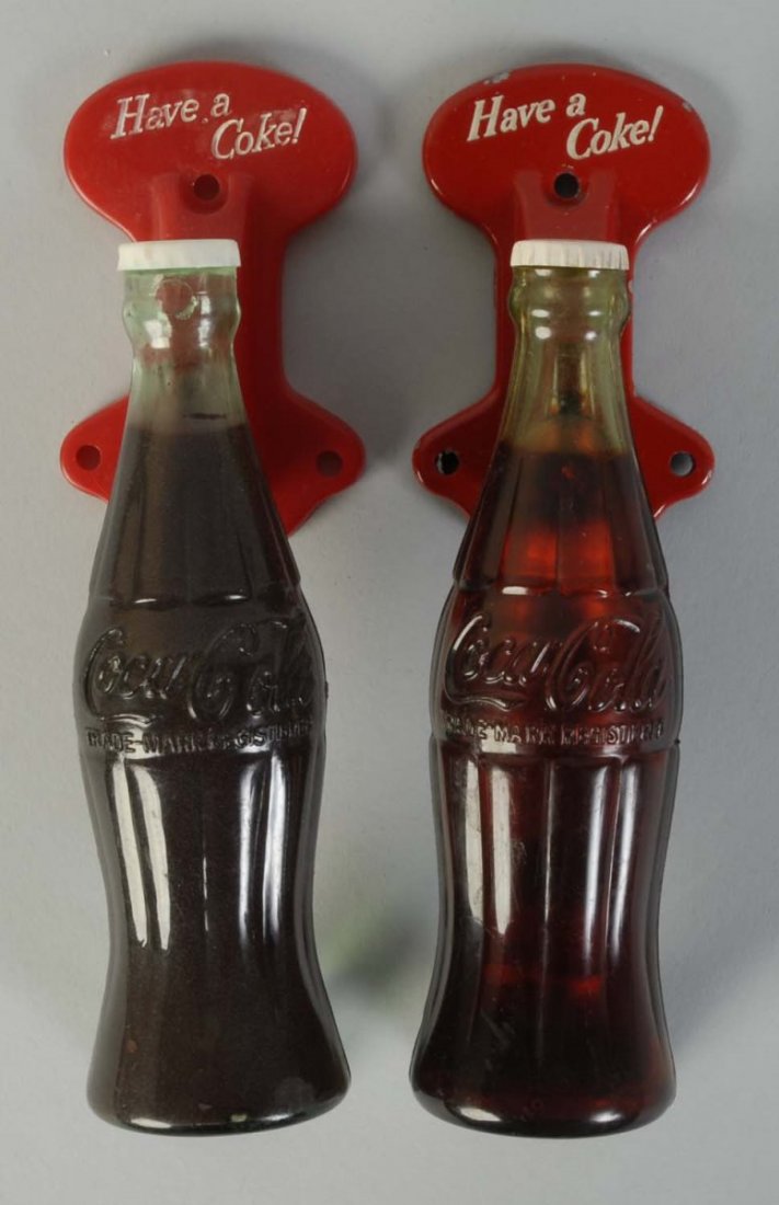 Lot of 2: 1950s Coca-Cola Door Pull Handles.: One is metal and plastic, the other all plastic. Light marks/wear only on either piece. Condition (Excellent - Near Mint). Size Each: 7 - 3/4" T.