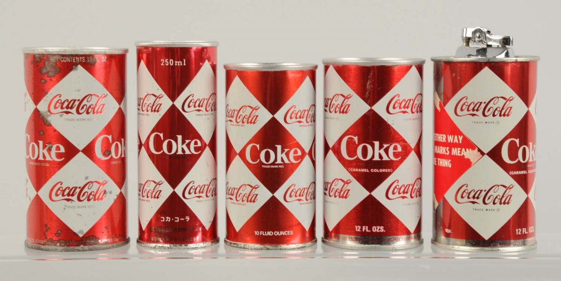 Lot of 5: 1960s Coca-Cola Cans.: One Asian, one French Canadian, others. Small dark stains on two cans. Condition (Very Good - Near Mint). Size Largest: 5 - 1/4" T.