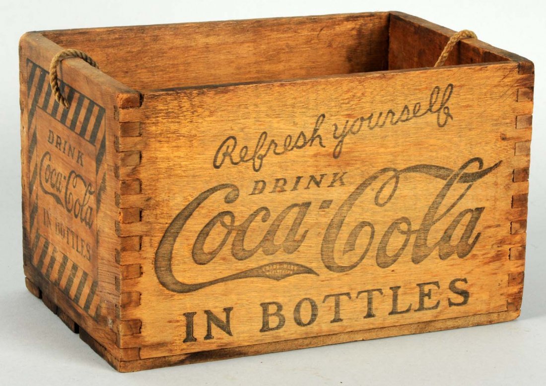 1920's Coca-Cola Dovetailed Wooden Carrier.: Original rope handle. Great remaining stencils and mild stains. Condition (Excellent). Size 8" L.