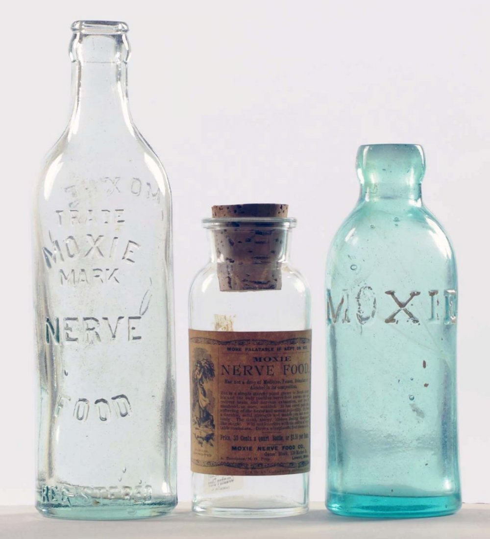 Lot of 3: Small Glass Moxie Bottles.: Early group with little wear. Squatty bottle, not original to label. Condition (Near Mint). Size Largest: 8 - 3/4" T.