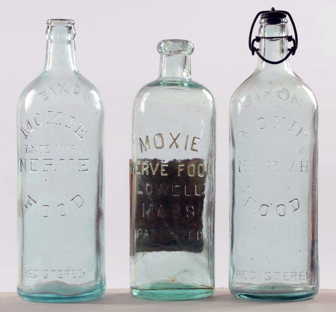Lot of 3: Glass Moxie Nerve Food Bottles.: The light green has its original stopper and only over paint to lettering on one. Condition (Very Good - Excellent). Size Largest: 10 - 3/4".