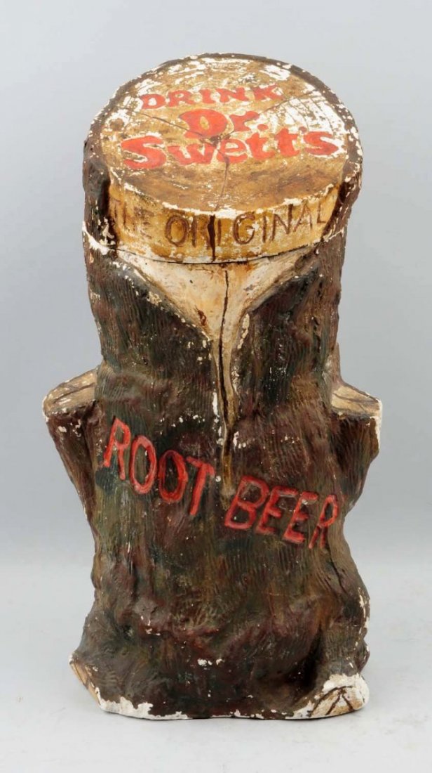 Large Dr. Swett’s Figural Stump Syrup Dispenser.: Embossed chalk ware with original spigot and tin liner. General wear with a number of small color chips/nicks, rubs, but still makes a statement. Condition (Very Good). Size 21" T.
