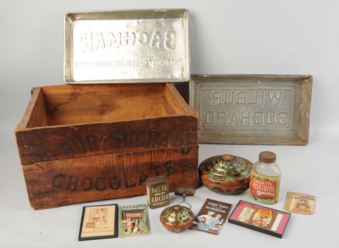 Lot of Wilbur Chocolate Advertising Items.: Wooden crate. Two covered tins. Four pamphlets glass jar, lidded broom holder. Condition (Excellent). Size 21" L.