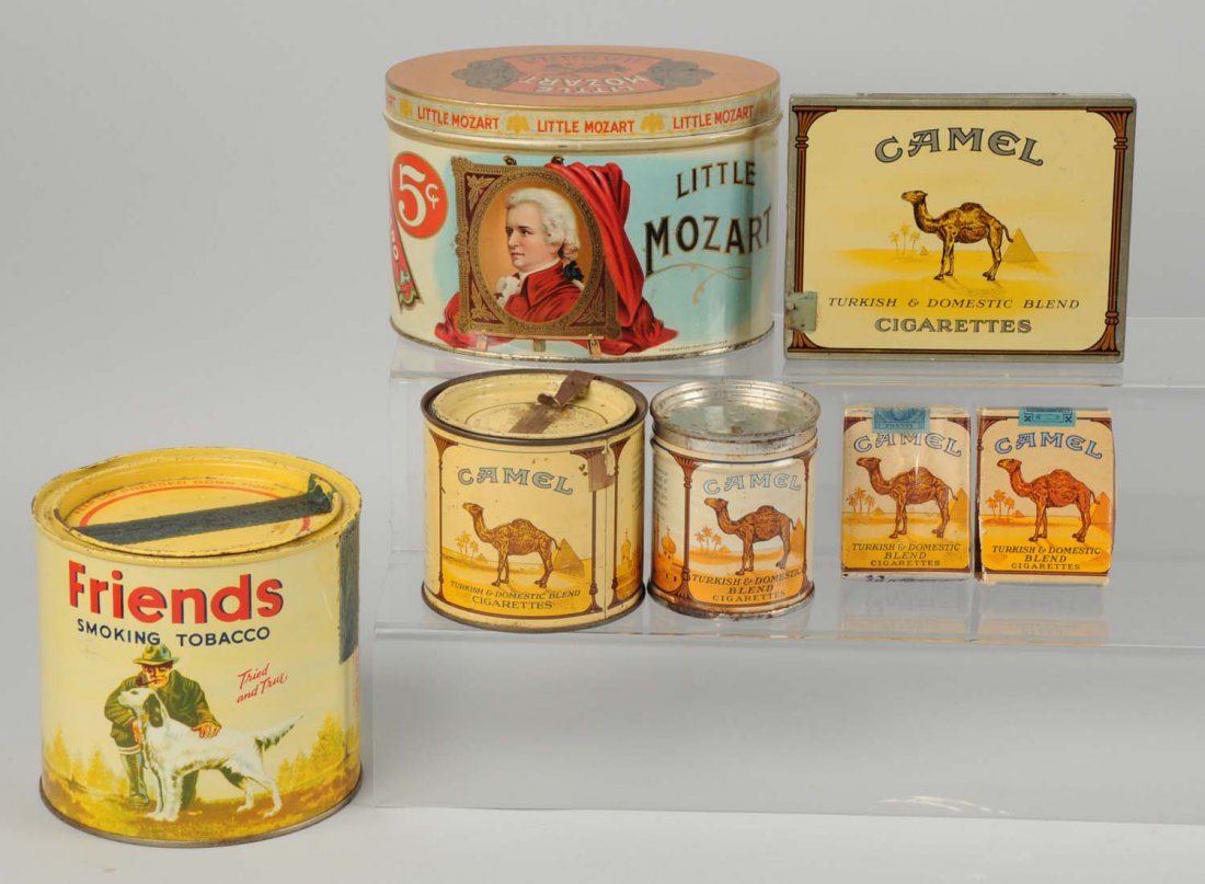 Lot of 7: Tobacco Tins.: Includes Camel cigarette pack and dummy pack. Light overall wear. Size Largest: 6 -1/2" L.